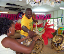 Members of SVG Players Int'l Mas Band work on costumes at their mas camp in Kingstown in preparation for Mardi Gras on July 7.
