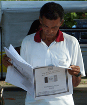 A man in Bequia, the Grenadines, reads a copy of the proposed constitution published in local newspapers on Friday. 