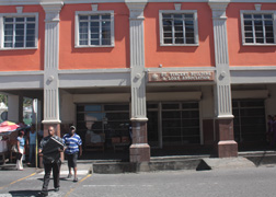 Pedestrians walk in front of the Building & Loan Association Building in Kingstown on Thursday, Feb. 7. Prime Minister Dr. Ralph Gonsalves announced Monday that there was a $10 million run on the institution in 2009. 